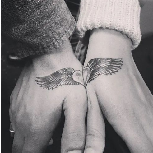 Half heart with wings hand tattoos
