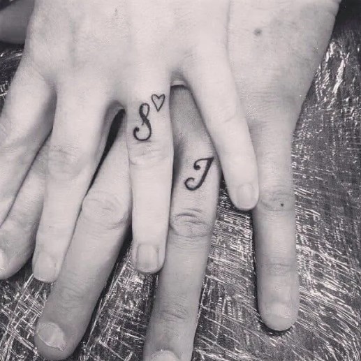 Initial ring finger tattoos